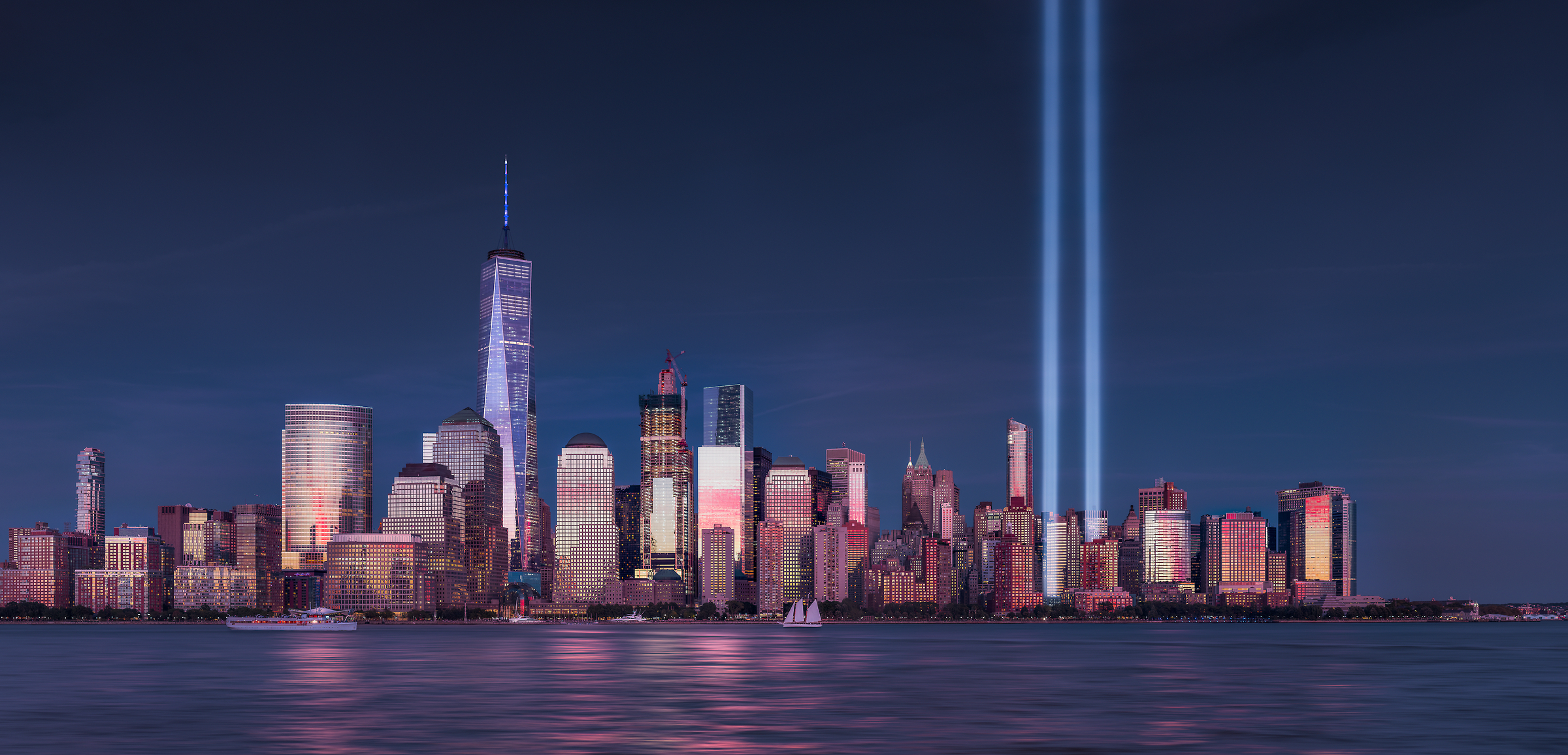 597 megapixels! The highest resolution VAST photo of the September 11th 9/11 Tribute in Light memorial, the World Trade Center, and the Manhattan city skyline at sunset in New York City; created by Dan Piech.