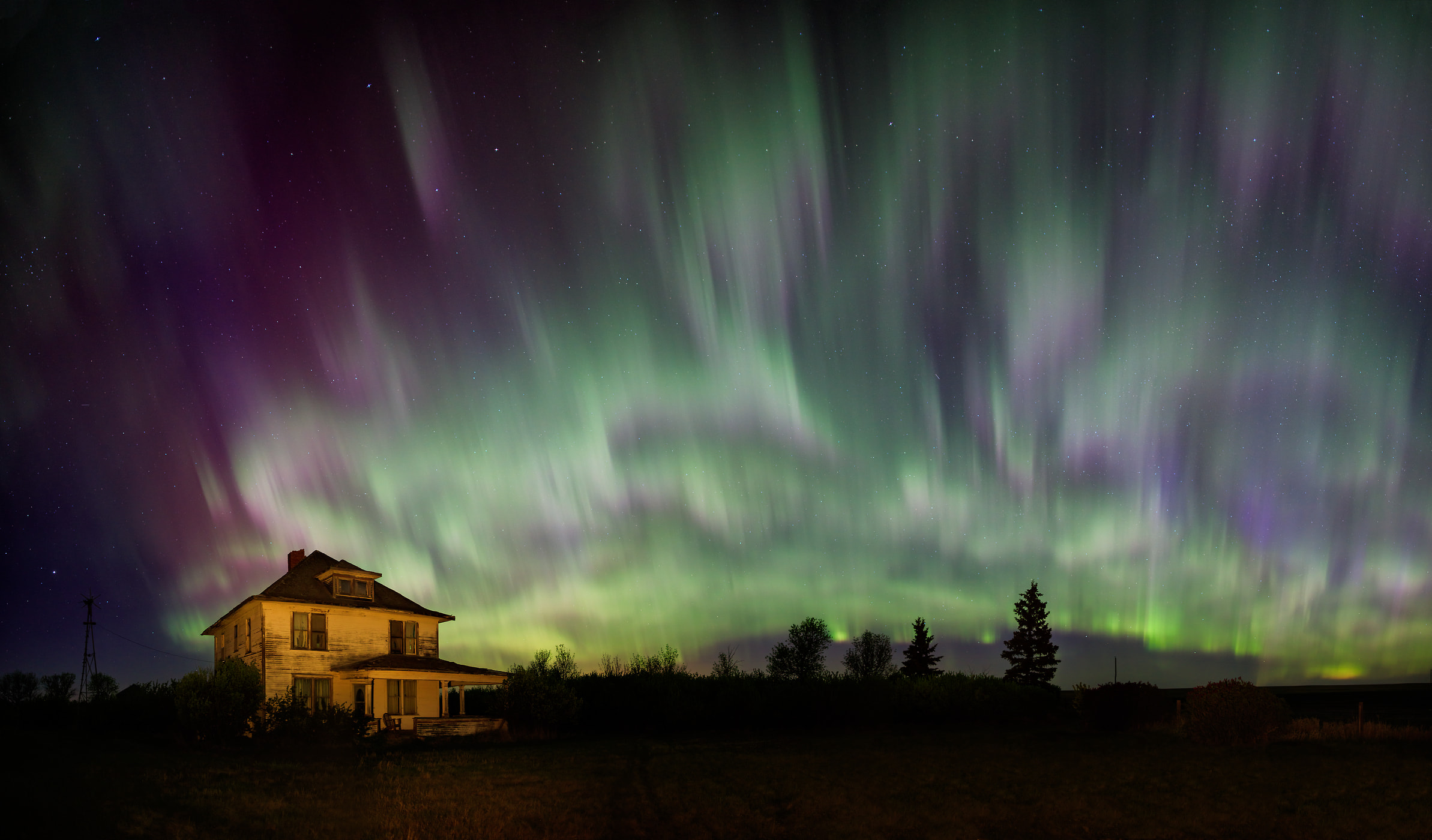 191 megapixels! A very high resolution, large-format VAST photo of an eerie creepy abandoned house under the Aurora Borealis Northern Lights; fine art landscape photo created by Scott Dimond in Alberta, Canada.