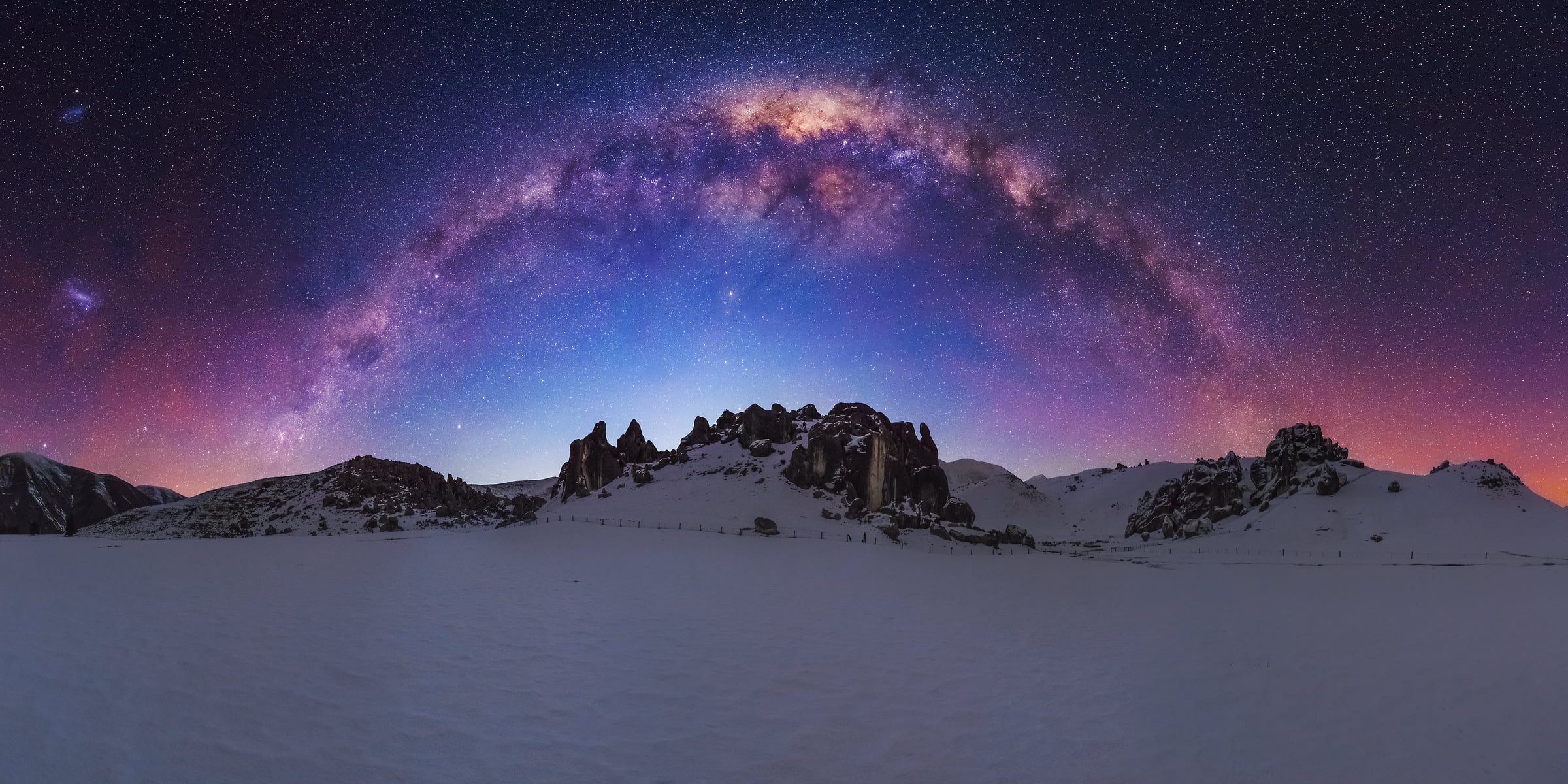 144 megapixels! A very high resolution, large-format VAST photo print of the night sky, milky way, and stars over a snowy scene of rock formations; fine art astrophotography landscape photo created by Paul Wilson in New Zealand.