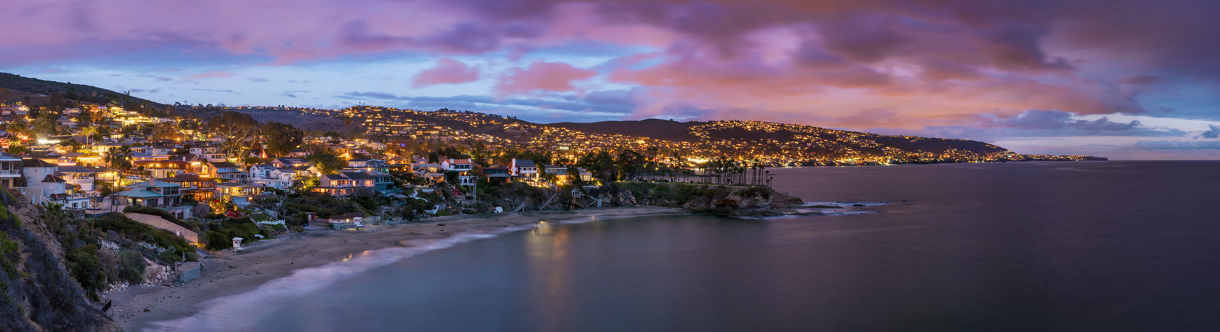 193 megapixels! A very high resolution, large-format VAST photo of a beach town at dusk with a sunset; panorama photograph created by Jim Tarpo in Laguna Beach, California.