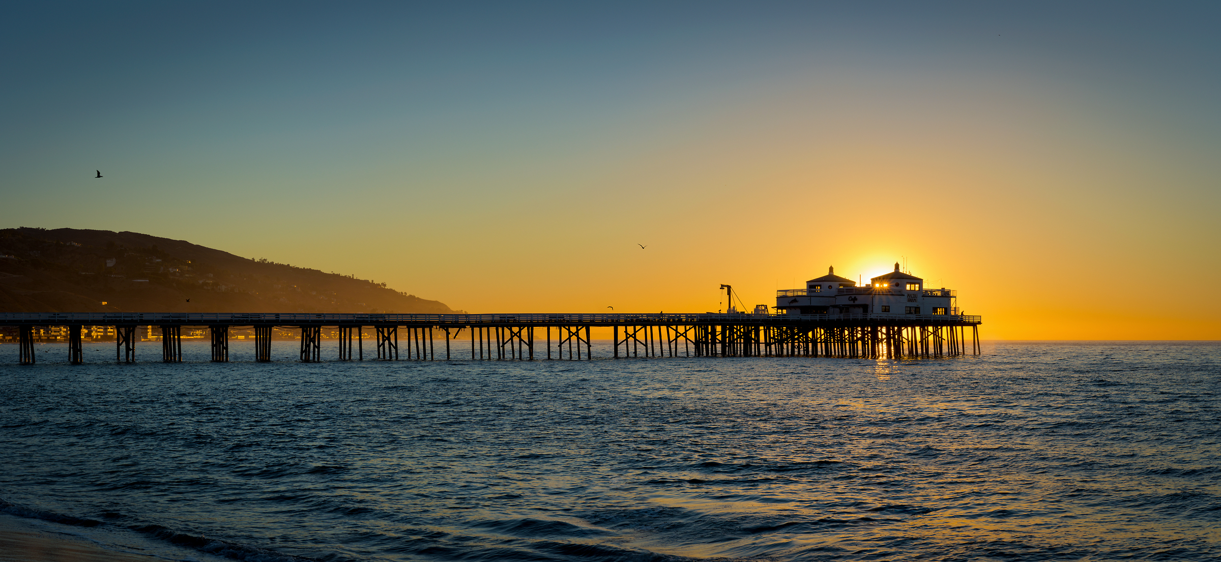 112 megapixels! A very high resolution, large-format VAST photo of the Malibu Pier at sunrise created by Jim Tarpo in Malibu, California.