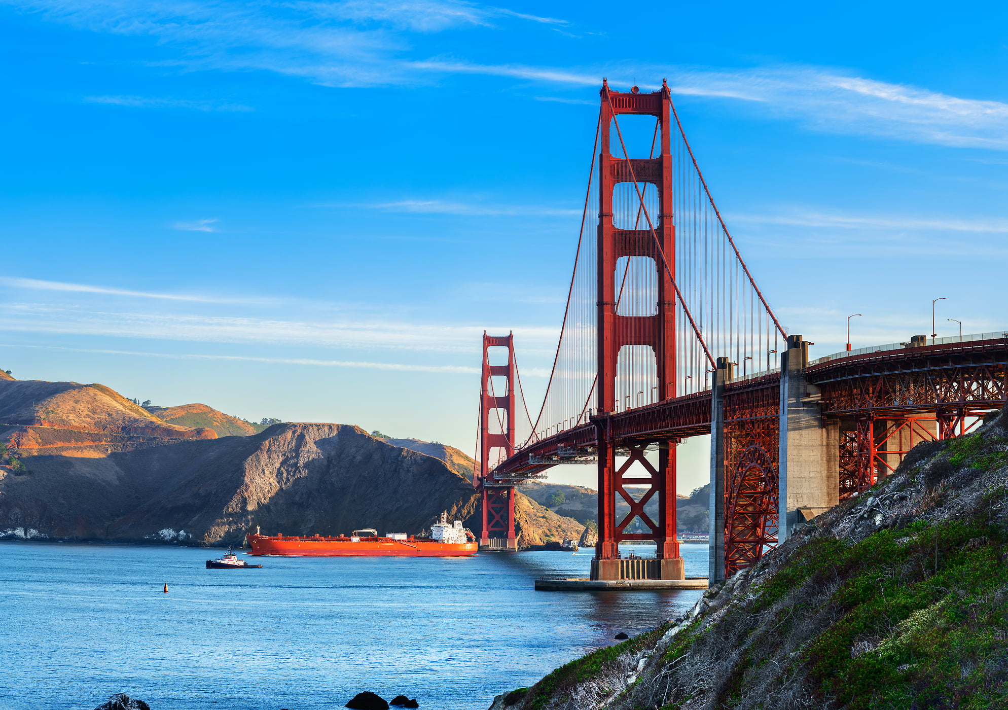 588 megapixels! A very high resolution, large-format VAST photo print of the Golden Gate Bridge with a blue sky in the background and the San Francisco Bay in the foreground; photograph created by Jim Tarpo in Marshall's Beach, San Francisco, California.