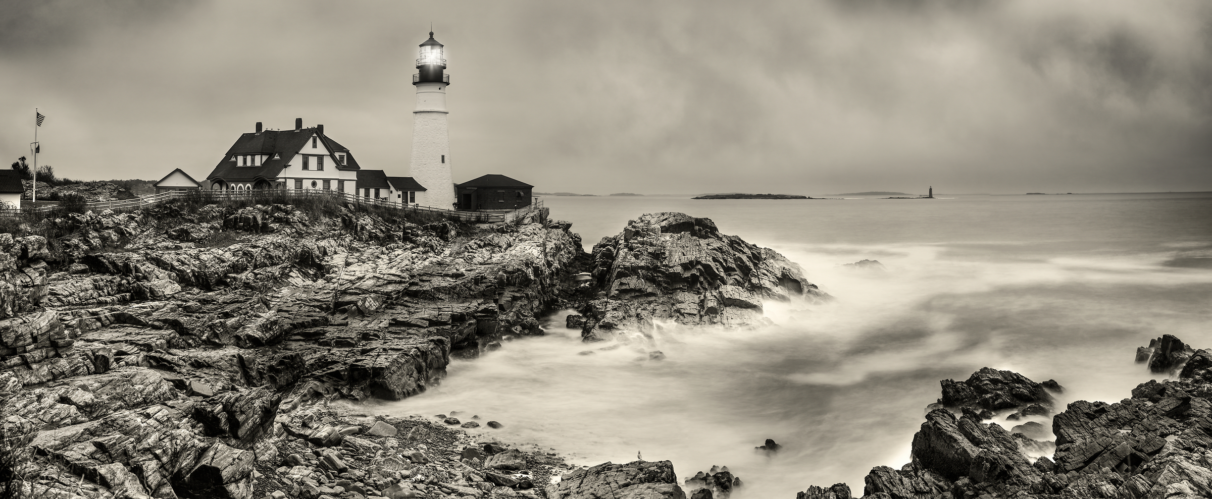 521 megapixels! An artistic photograph of a lighthouse with the ocean and rocks; photograph created by Phil Crawshay in Portland Head Lighthouse, Portland, Maine.