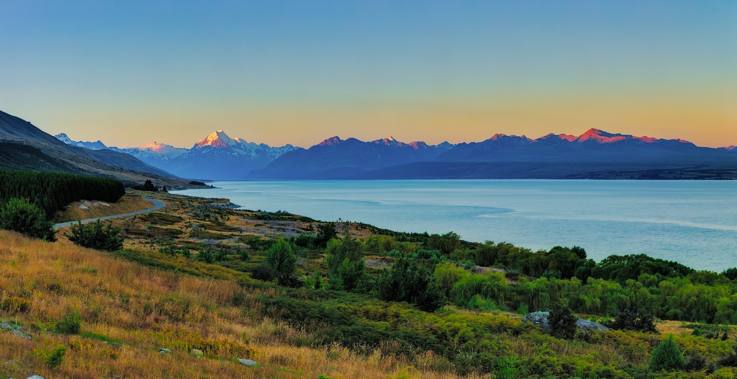 197 megapixels! A very high resolution, large-format VAST photo print of sunset over Lake Pukaki with mountains in the background; landscape photograph created by John Freeman in Mount Cook Road, Ben Ohau 7999, New Zealand.