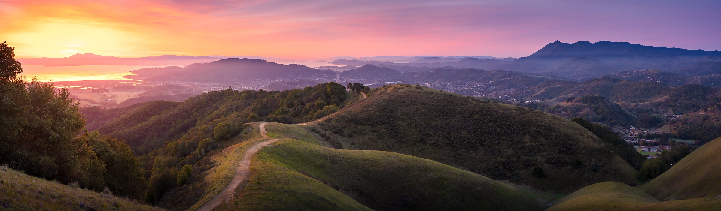 180 megapixels! A very high resolution, large-format VAST photo print of a hiking trail on rolling hills while a beautiful sunrise happens in the sky; landscape panorama photograph created by Jeff Lewis in Marin County, California.