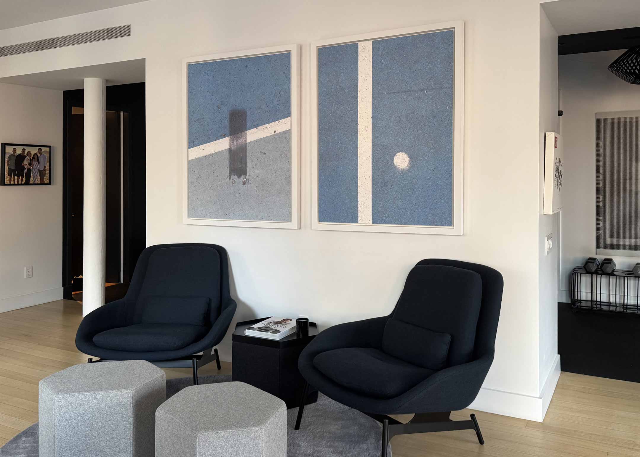 A picture of two framed VAST photos from Dan Piech's Concrete Canvas series hanging on a wall.