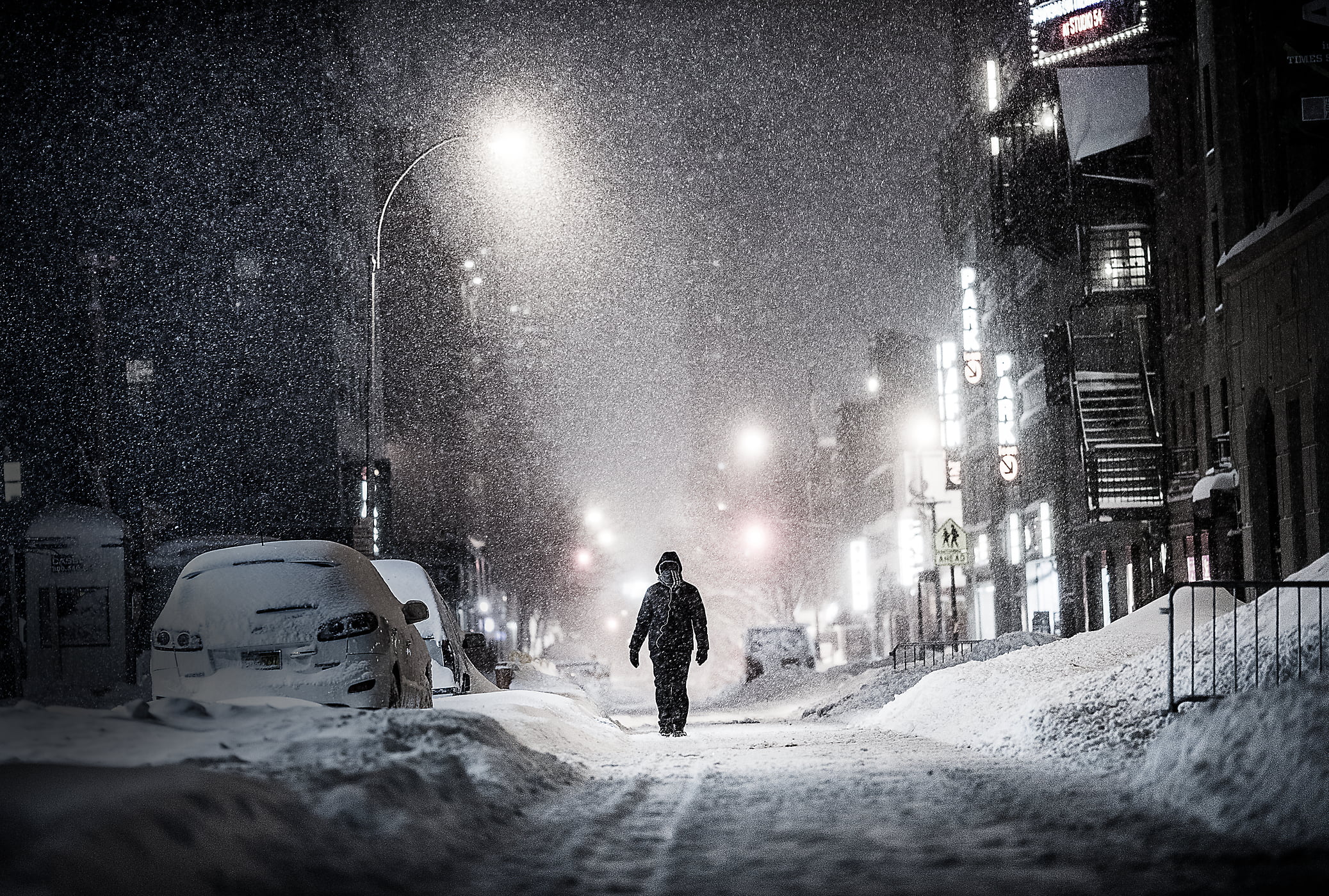 50 megapixels! A very high resolution VAST photo of a lonely person walking down an alley during the 2016 winter snow blizzard at night in New York City; created by Dan Piech