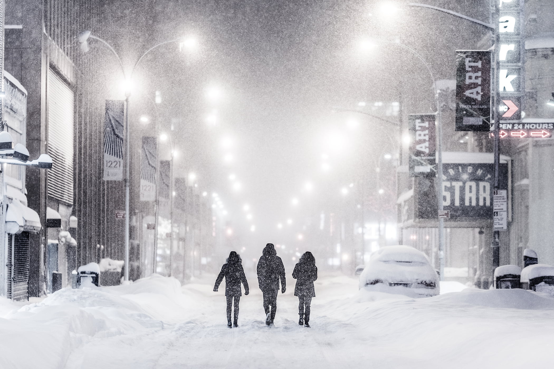 50 megapixels! A very high definition VAST photo of people walking down the street in Times Square during the 2016 winter snow blizzard at night in New York City; created by Dan Piech