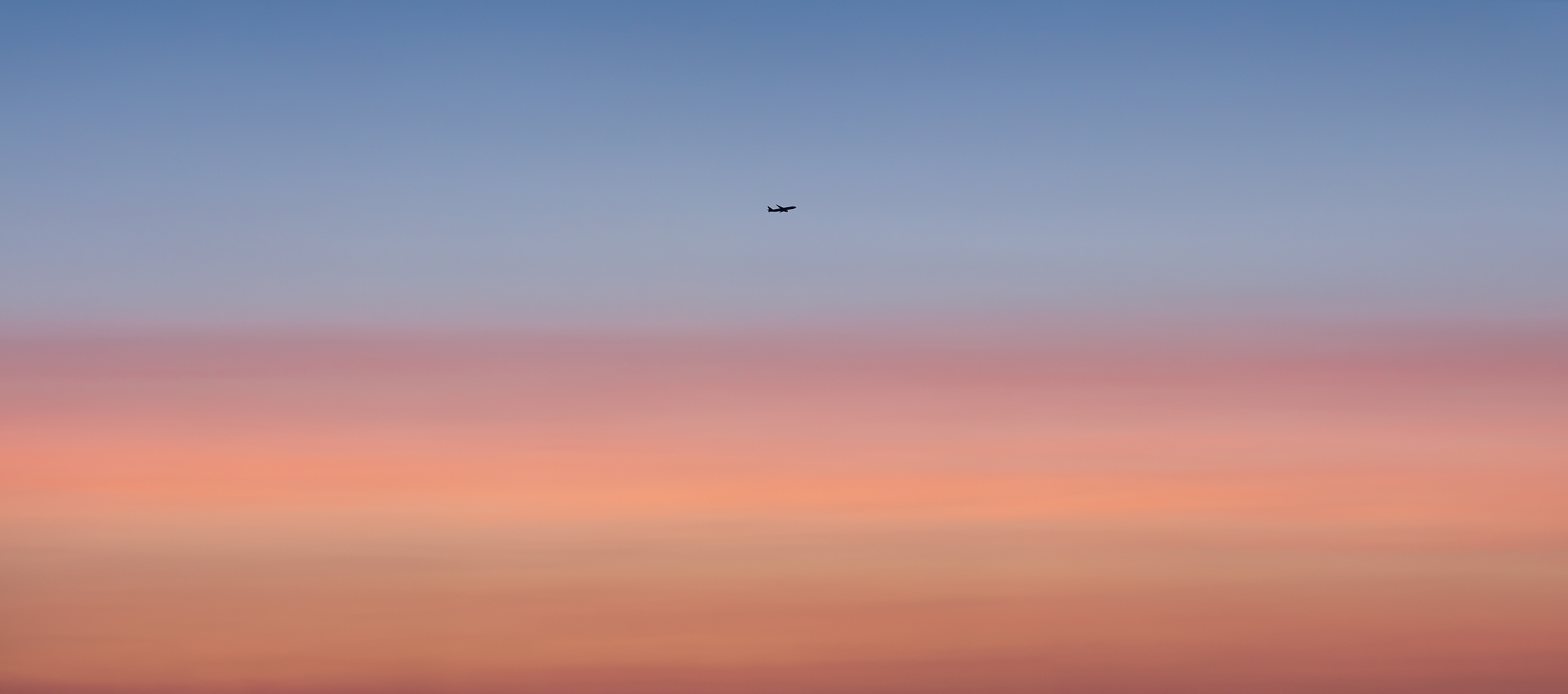 452 megapixels! A very high resolution, large-format VAST photo of an airplane taking off or landing in a vibrant, pastel, colorful sunset; fine art airplane photograph created by Dan Piech in New York City.
