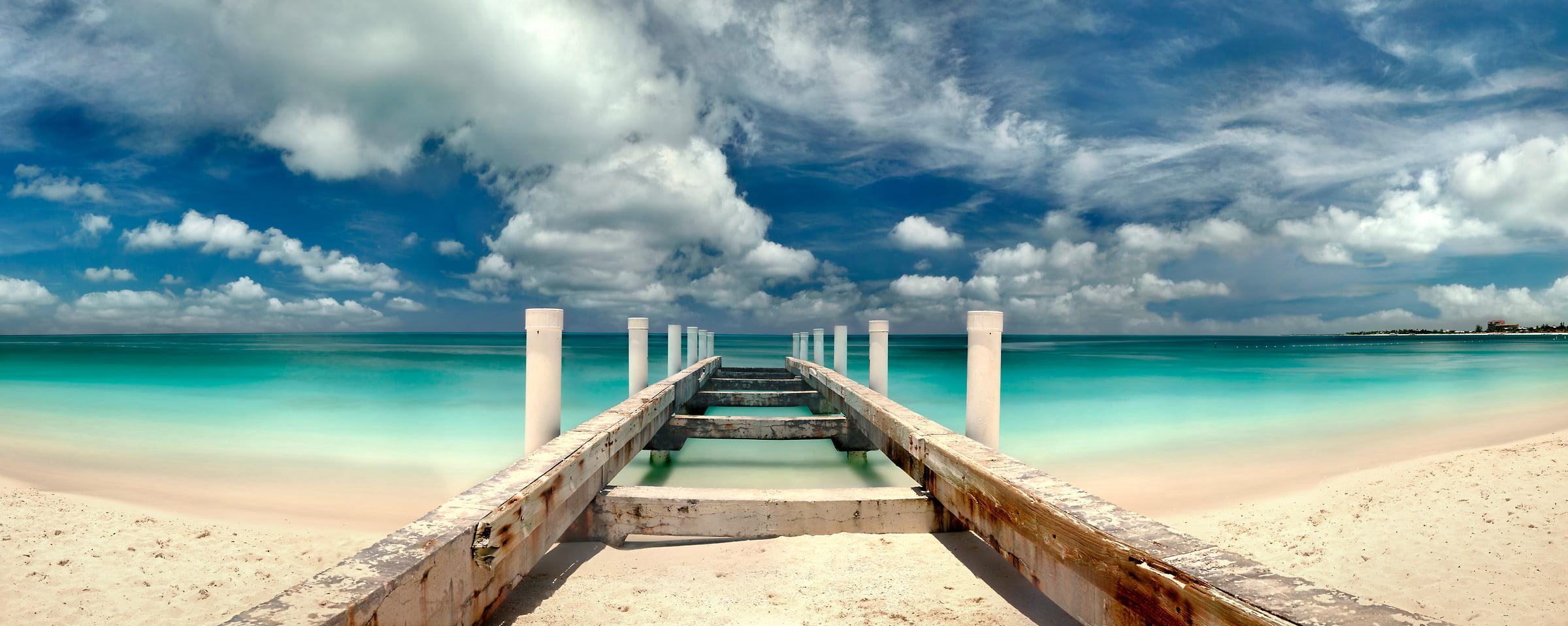245 megapixels! A very high resolution photo of a beach and blue ocean with an old pier; VAST photo created by Phil Crawshay in Grace Bay, Turks and Caicos Islands