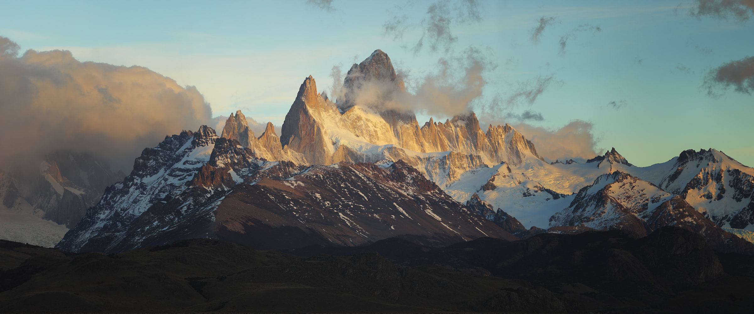 158 megapixels! A very high resolution, large-format VAST photo print of an epic mountain scene with clouds and blue sky above misty mountains; landscape photograph created by Alexandre Deschaumes in El chalten, Argentina, Patagonia.