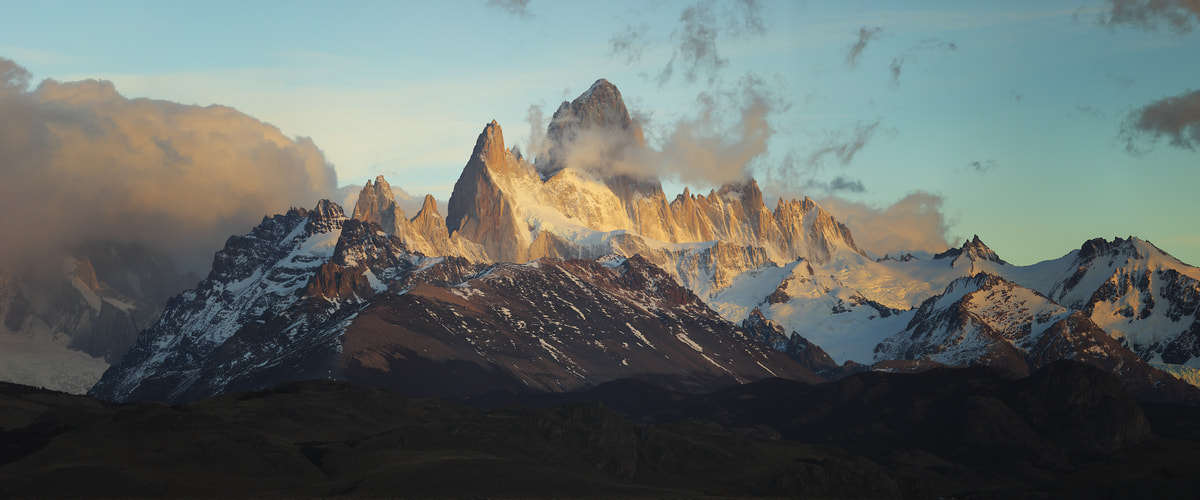 158 megapixels! A very high resolution, large-format VAST photo print of an epic mountain scene with clouds and blue sky above misty mountains; landscape photograph created by Alexandre Deschaumes in El chalten, Argentina, Patagonia.