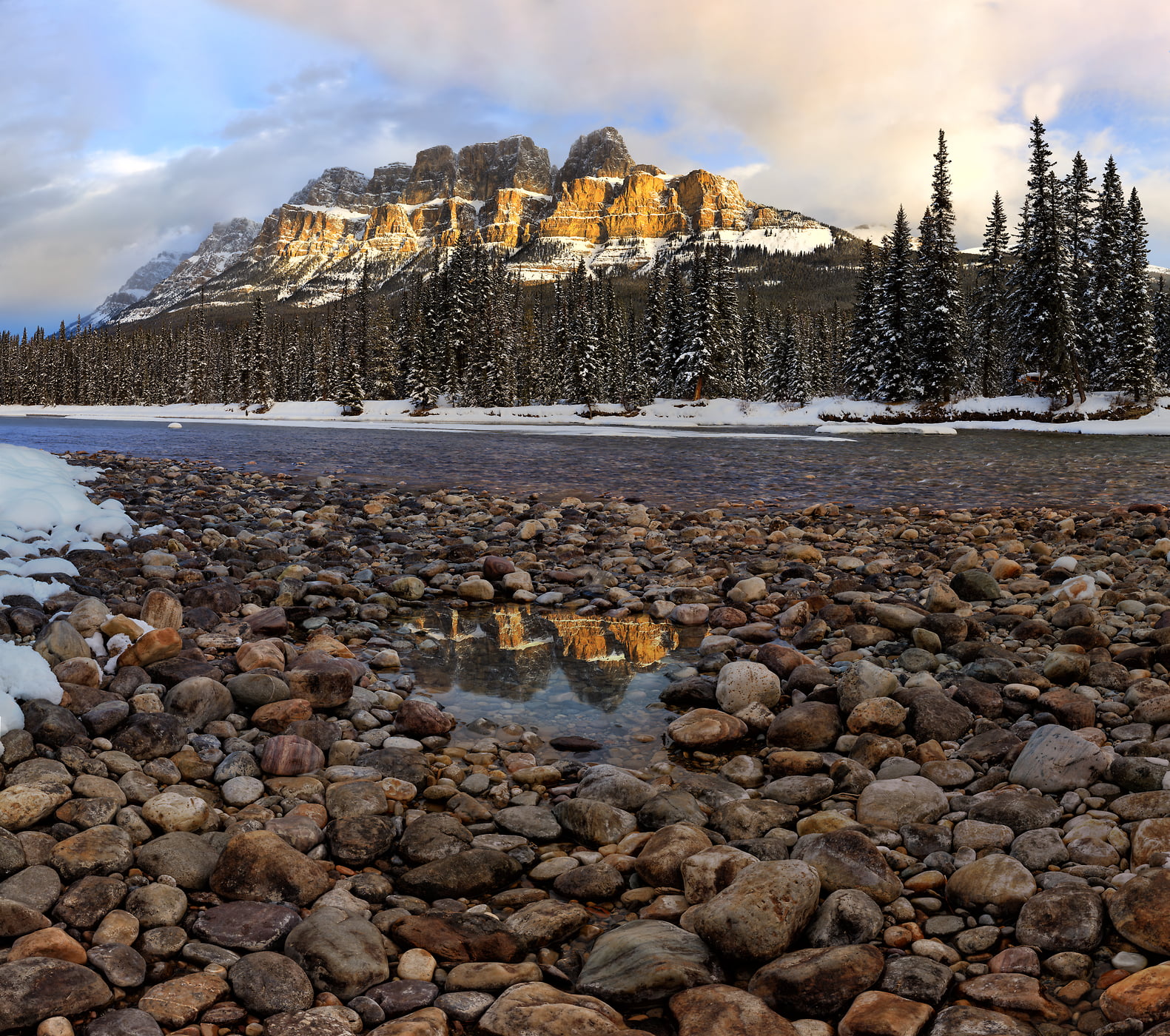 1,123 megapixels! A very high resolution, large-format VAST photo print of a stream with rocks on the side, backdropped by a snowy forest and large mountain range with Castle Mountain; landscape photograph created by Scott Dimond in Banff National Park, Alberta, Canada.