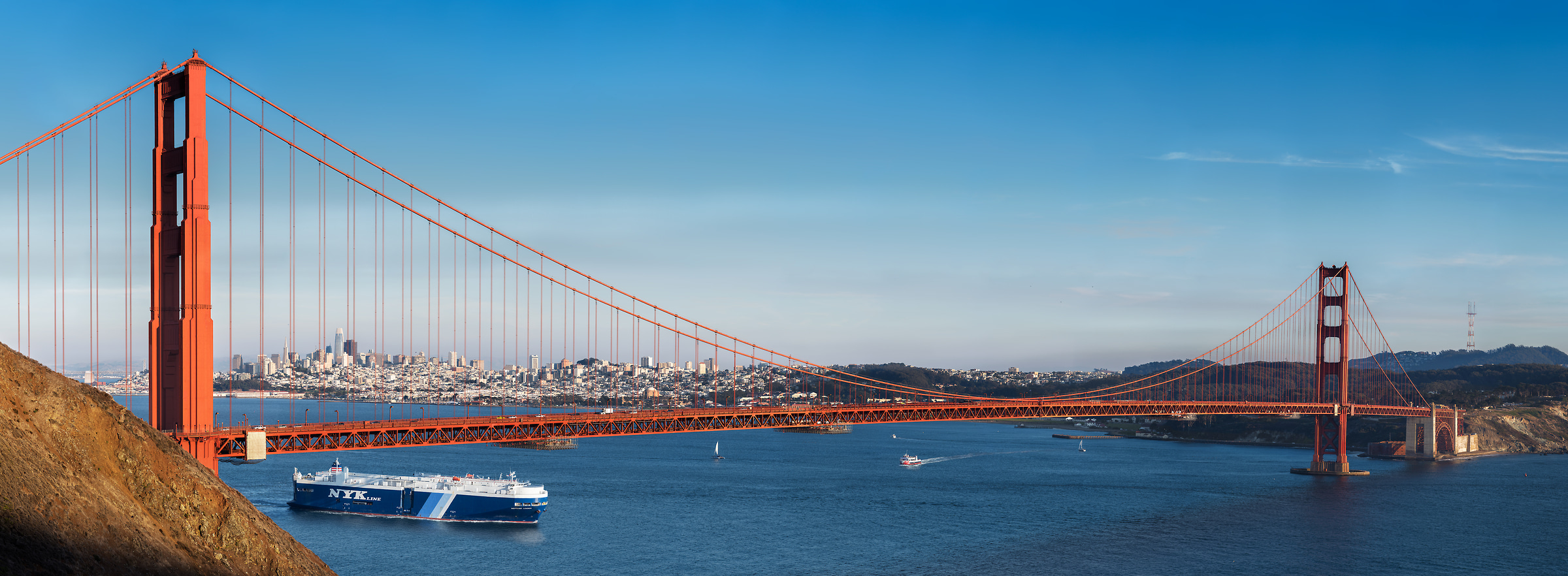698 megapixels! A very high resolution, large-format VAST photo print of the Golden Gate Bridge in front of the San Francisco skyline on a blue sky day; photograph created by Jim Tarpo in Mill Valley, California.