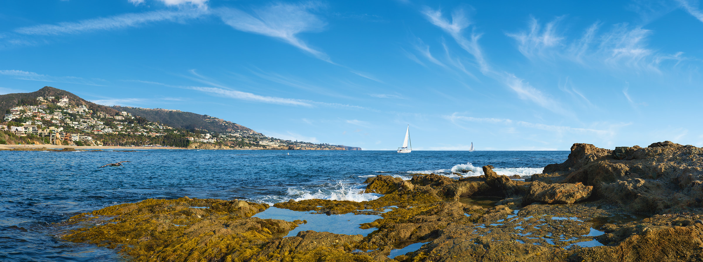 141 megapixels! A very high resolution, large-format VAST photo print of a sailboat on the ocean with rocks and waves in the foreground; seascape photograph created by Jim Tarpo in Laguna Beach, California