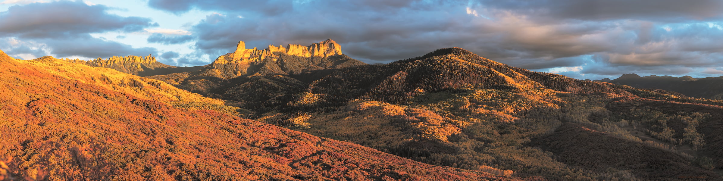 1,118 megapixels! A very high resolution, panorama photo of forested hills and mountains in Colorado at sunset; landscape photograph created by John Freeman in Owl Creek Range, Ridgeway, Colorado