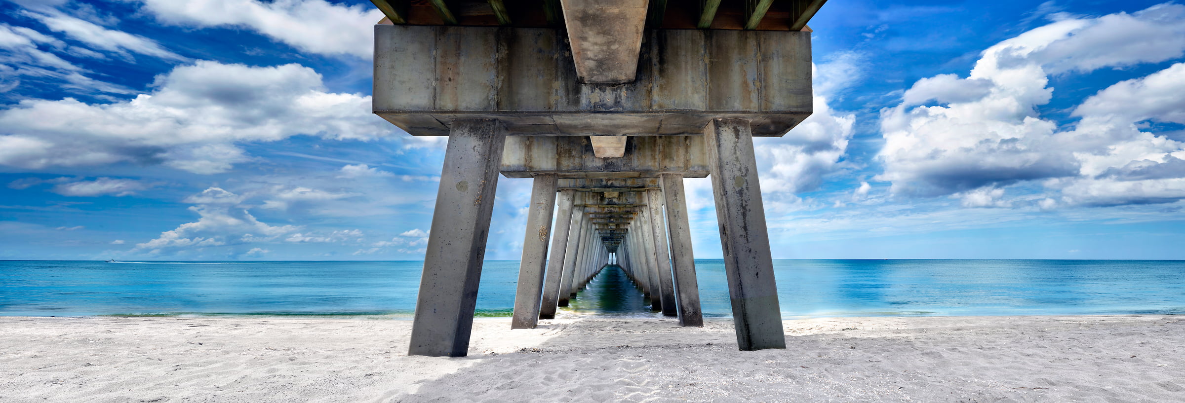 306 megapixels! A very high resolution, large-format VAST photo print of a beach scene under a pier with the ocean and sand; photograph created by Phil Crawshay in Venice Pier, Venice, Florida
