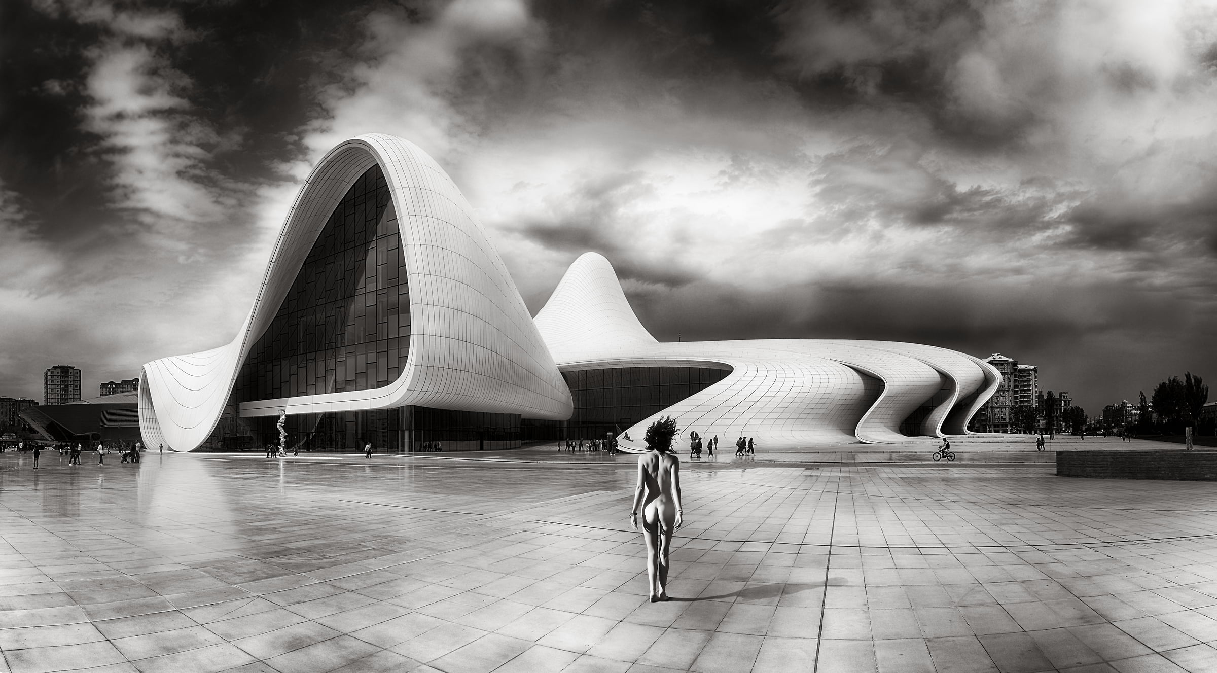 159 megapixels! A very high resolution, large-format VAST photo print of a nude woman in a plaza in front of a modern building; surreal, black & white nude photograph created by Peter Rodger in Heydar Aliyev Center, Baku, Azerbaijan