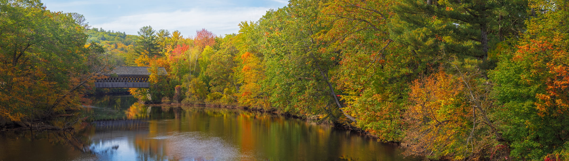 1,058 megapixels! A very high resolution, large-format VAST photo print of a covered bridge over a river in New England in autumn; photograph created by John Freeman in Bridge Street, Henniker, New Hampshire.