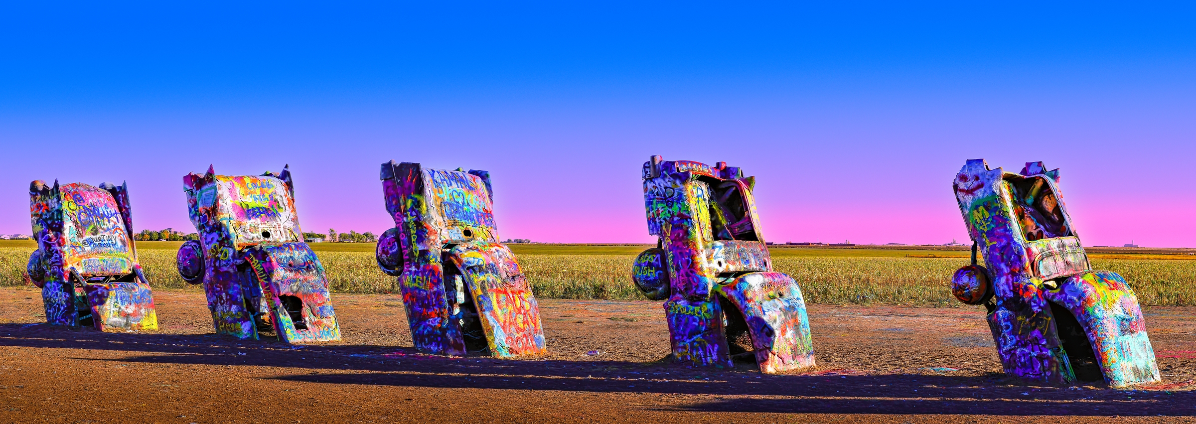 155 megapixels! A very high resolution, large-format VAST photo print of an art installation of old cars buried in the ground; photograph created by David David in Amarillo, Texas