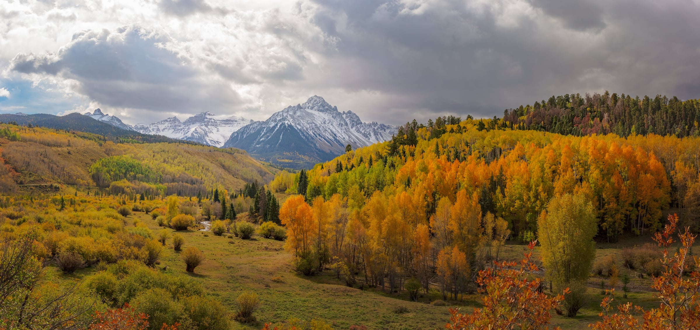146 megapixels! A very high resolution, large-format VAST photo print of the San Juan mountains in Colorado with autumn foliage on trees in the foreground; landscape photograph created by John Freeman in San Juan Mountains, Colorado.