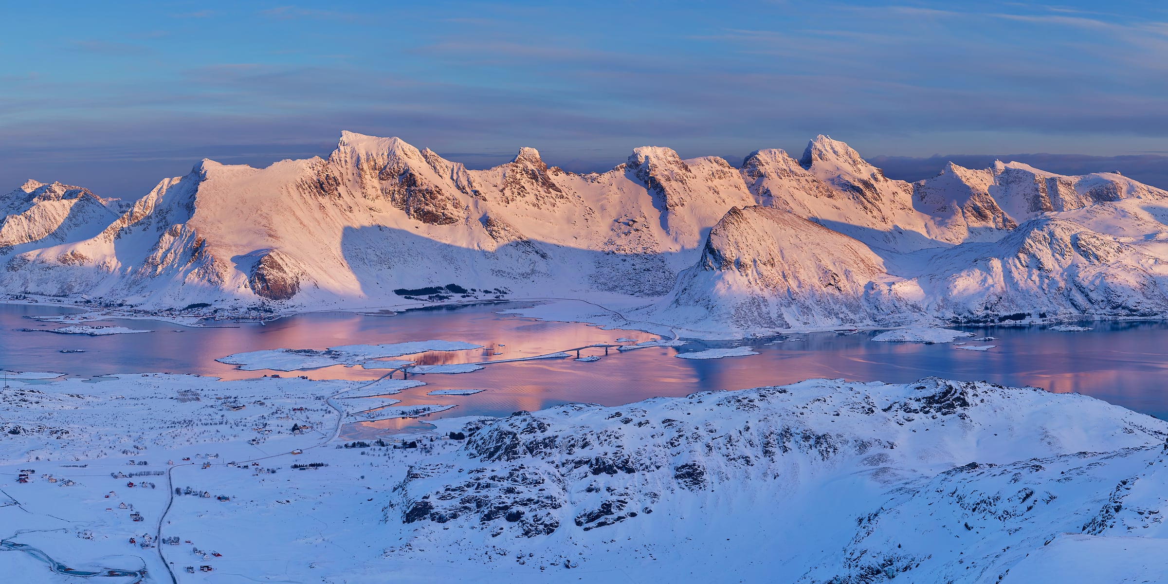 1,375 megapixels! A beautiful mountain landscape scene with snow-covered mountains illuminated by sunset with a river; photograph created by Martin Kulhavy in Ryten Mountain, Lofoten, Norway.