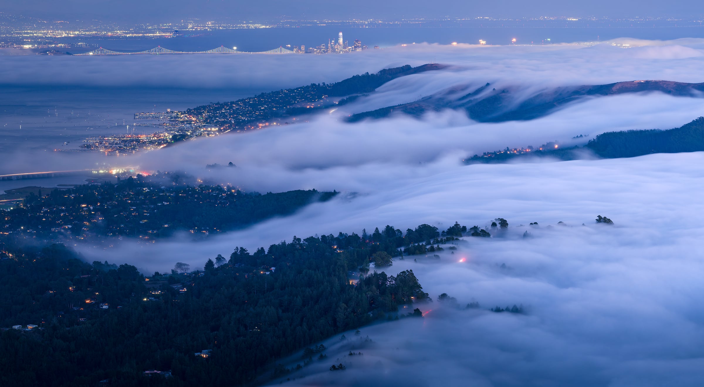 158 megapixels! A very high resolution, large-format VAST photo print of fog rolling over hills and a city at night; landscape photograph created by Jeff Lewis from Mt. Tamalpais in Marin County, California.