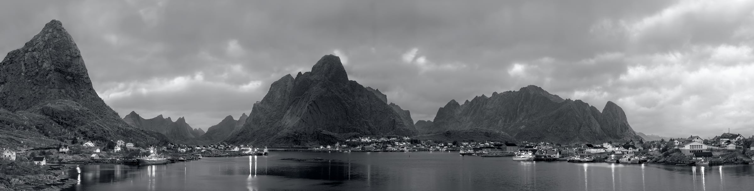 1,701 megapixels! A very high resolution, large-format VAST photo print of the landscape of Reine, Lofoten, Norway with mountains and a fishing village at dusk; black & white landscape photograph created by Ennio Pozzetti in Reine, Lofoten, Norway.