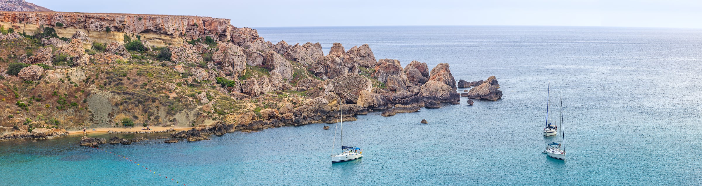 223 megapixels! A very high resolution, large-format panorama photo of a scene in Malta with a rocky beach, sailboats, and the ocean; seascape photograph created by Assaf Frank in Ghajn Tuffieha Bay, Malta, Europe.