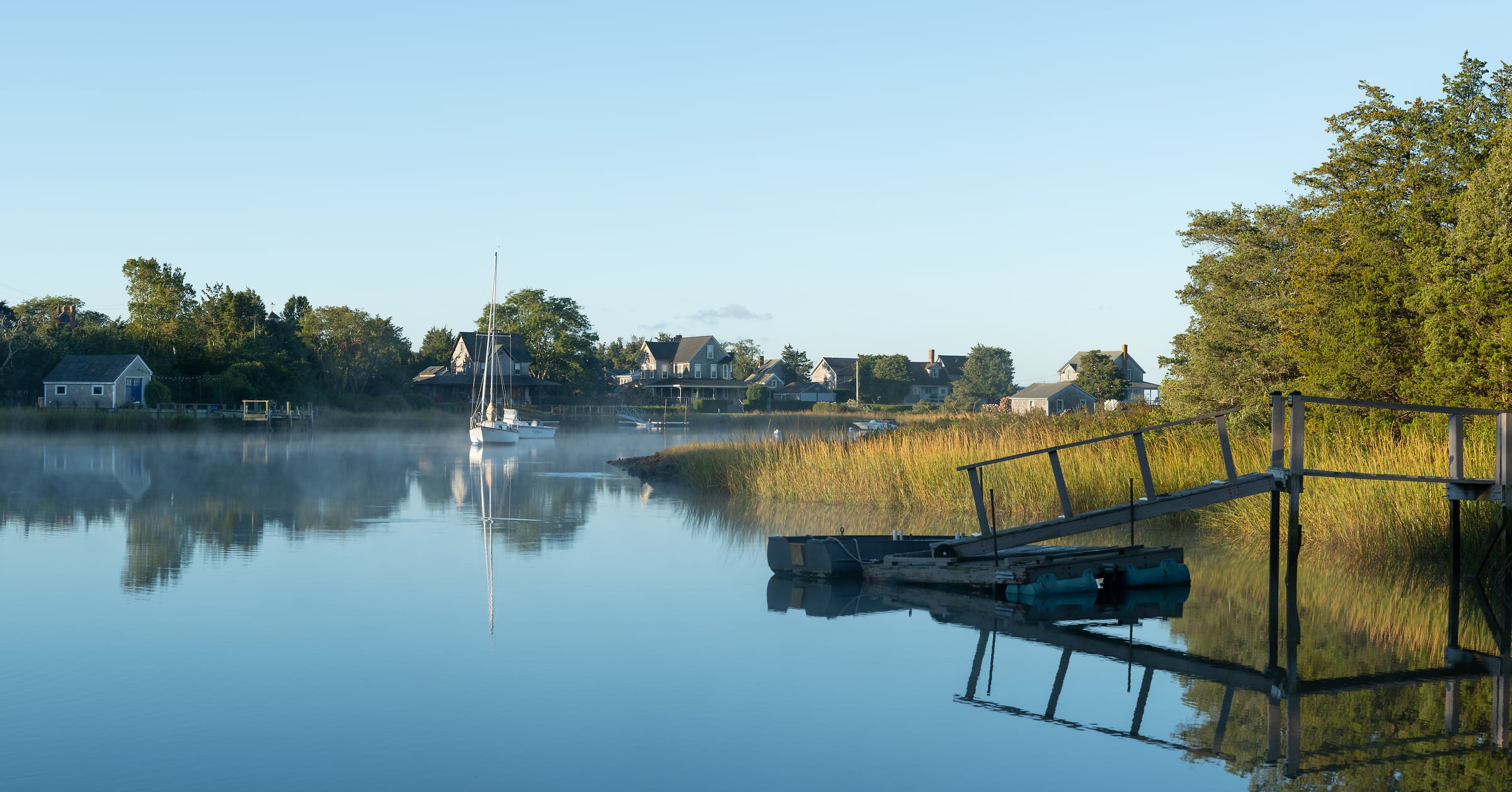 304 megapixels! A very high resolution, large-format VAST photo print of a beautiful, peaceful harbor in the morning with a sailboat, a dock, water plants, and quaint houses; fine art photograph created by Greg Probst in Snug Harbor, Massachusetts.