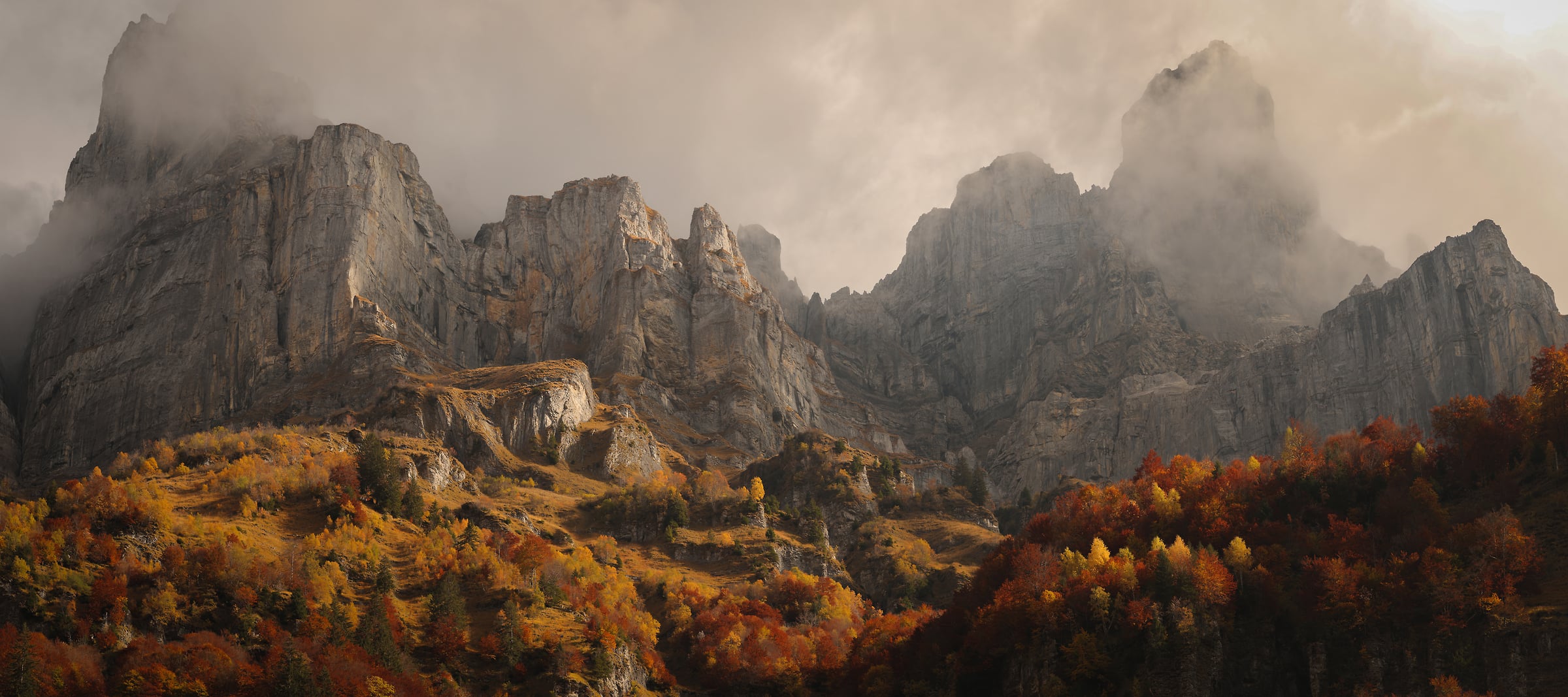 273 megapixels! A very high resolution, large-format VAST photo print of mountains in autumn with beautiful red and orange leaves on the trees and mist on the mountain peaks; fine art photograph created by Alexandre Deschaumes.