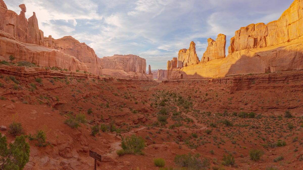 1,336 megapixels! A very high resolution, large-format VAST photo print of the Park Avenue trail in Arches National Park with a hiking trail leading through a valley formed by large rock formations; landscape photograph created by John Freeman in Arches National Park, Utah.