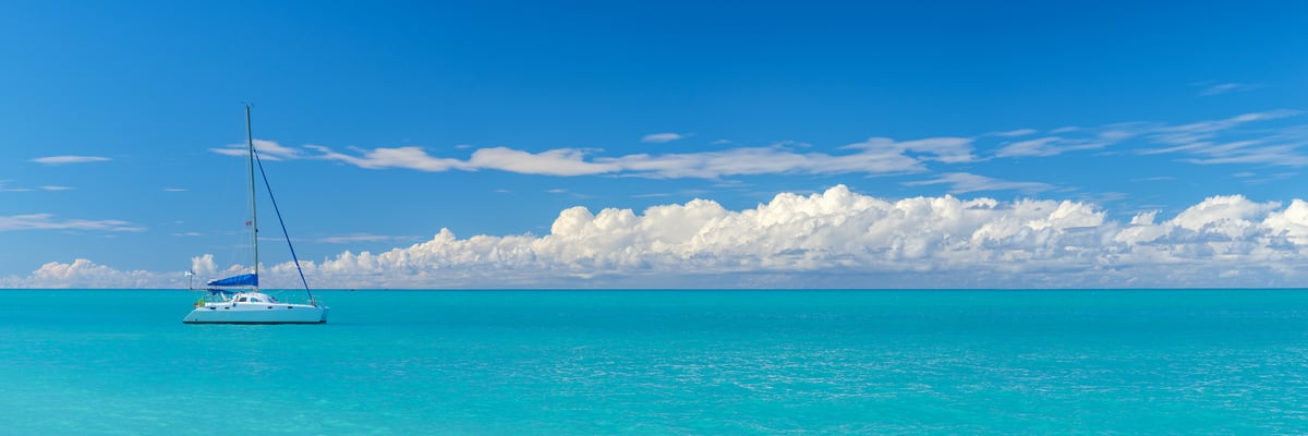 228 megapixels! A very high resolution, large-format VAST photo print of a sailboat on beautiful turquoise water in the calm Caribbean on a blue sky day with puffy white clouds in the sky; photograph created by Assaf Frank in St John's, Antigua and Barbuda.